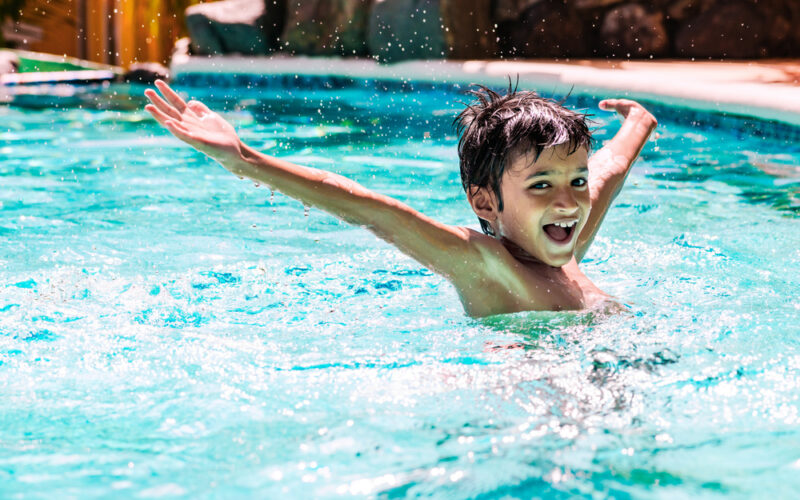 Young,Boy,Kid,Child,Eight,Years,Old,Splashing,In,Swimming