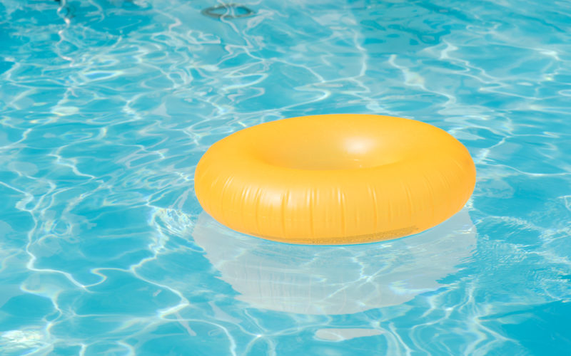 Bright,Orange,Float,In,Blue,Swimming,Pool,,Ring,Floating,In