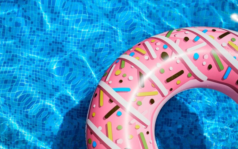 Pink,Inflatable,Ring,In,A,Blue,Outdoor,Pool.,Poolside,Atmosphere.